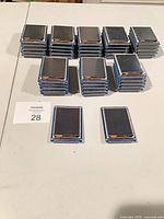 Stacks of identical LCD circuit boards, showing front screens