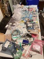 overview of table covered with various electronic parts and supplies