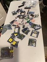 overview of table with many sealed antistatic bags containing computer components