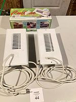 Two Cyclone Booster Fan Plus units with cords and plug