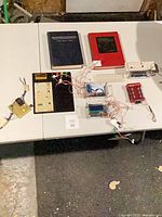 Overall view of books and electronic test boards on table
