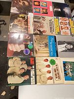 All twelve vinyl records laid out in three rows