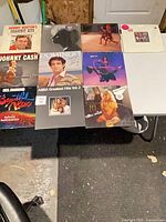 Full layout of nine record albums on table