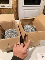 Two boxes filled with loose screws