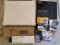 Overview of all materials including mat boards, adhesive roll box, canvas roll box, multiple photo paper packs