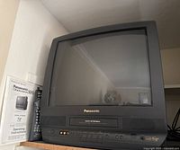 Front view of Panasonic CRT TV/VHS combo with remote and manual
