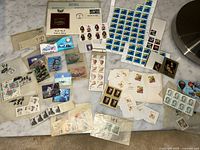 Overview of assorted uncancelled U.S. stamp sheets, blocks, singles and 3-D Bhutan stamps spread on surface