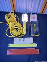 Full lot: trouble light with cord, slide rule with case, box, leaflet