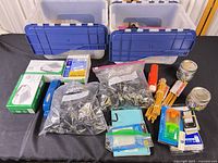 Overall lot showing two storage bins and assorted office supplies