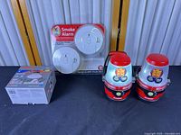 Overall lot view showing two lanterns, smoke alarm pack, Halo downlight box