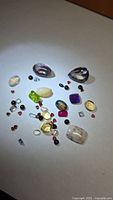 Group view of assorted loose gemstones on white background