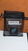 Opal in mesh pouch labelled Reflection of fall