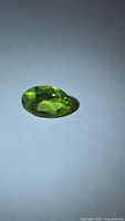 Top view of vivid green oval peridot