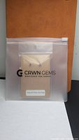 Earrings packaged in CRWN Gems resealable pouch front view