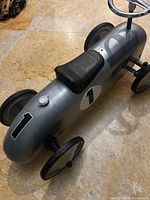 Side angle showing full car body, number decal, wheels, seat