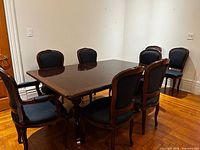 Six chairs around dining table showing set