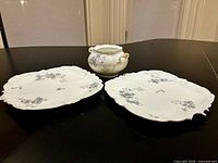 Overview of two plates and handled bowl