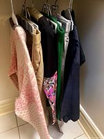 Group of hanging garments showing variety of colours and styles