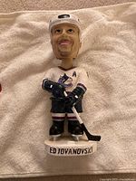 Front view of Ed Jovanovski bobblehead showing jersey front and base text