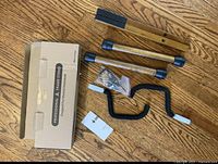 Box, acacia wood legs, crossbars, foam-padded cradle arms, hardware bag and manual