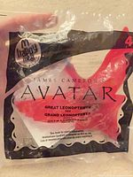 Front of sealed bag showing McDonald's Happy Meal logo, Avatar branding, item name Great Leonopteryx, and red toy inside