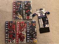 All six mini jerseys laid out; five sealed in packaging, one opened Naslund jersey on stand