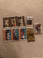 All nine unopened hockey card packs laid out on carpet
