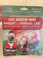 Front of packaged ugly sweater face mask