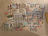 Entire spread of assorted Canadian stamps laid out on carpet