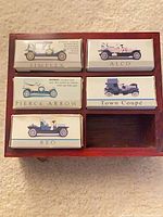 Wooden case with five boxed cars labelled Simplex, Alco, Pierce Arrow, Town Coupé, Reo