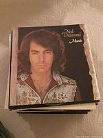 Stack of LPs top record Neil Diamond “Moods”