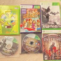 All six Xbox 360 game discs and cases arranged on surface