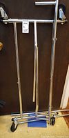 Garment rack folded with casters visible