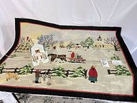 Overall view of hooked rug with ceramic church placed on top