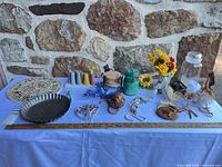 All items laid out on table against stone wall