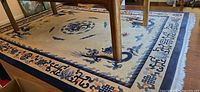 Full rug under table showing central dragon and border