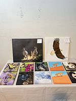 Overview of all canvases on table with two large prints standing