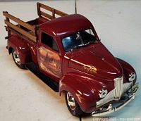 Front left view showing maroon finish, stake sides, Terry Redlin signature