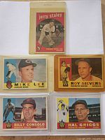 Front view of five 1960 Topps baseball cards in plastic sleeves: Jerry Staley, Mike Lee, Roy Sievers, Billy Consolo, Hal Griggs