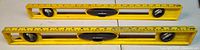 Top view of both yellow Stanley levels showing vials and inch markings