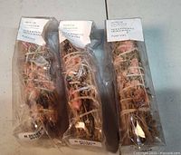 Three packaged smudge bundles front view