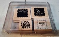 All four wood-mounted rubber stamps in plastic case, lid closed