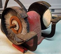 Front view showing wire brush wheel, cloth buffing wheel and red Wizard housing