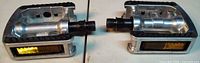 Both pedals side by side showing overall design, reflectors and spindles