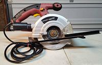 Left side view of Chicago Electric corded circular saw with fence and cord