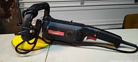Left side view of Drill Master polisher-sander showing wrapped cord and yellow pad