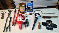 Overall view of tools, funnels, gear lube, coffee can, crank, brush, mower blade