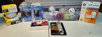Overview of boxed bulbs, plastic bin of assorted bulbs, packaged halogen tube and miniature bulb pack