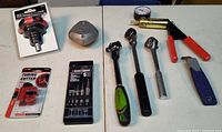 Overview of all loose and packaged tools laid out on table