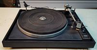 Front-angled view showing full turntable, platter, tonearm and controls